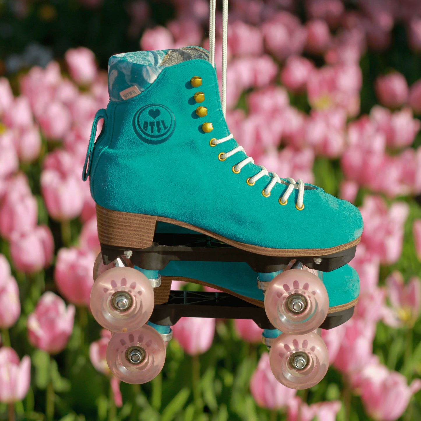 Damen Rollschuhe von BTFL vor rosafarbenen Tulpen